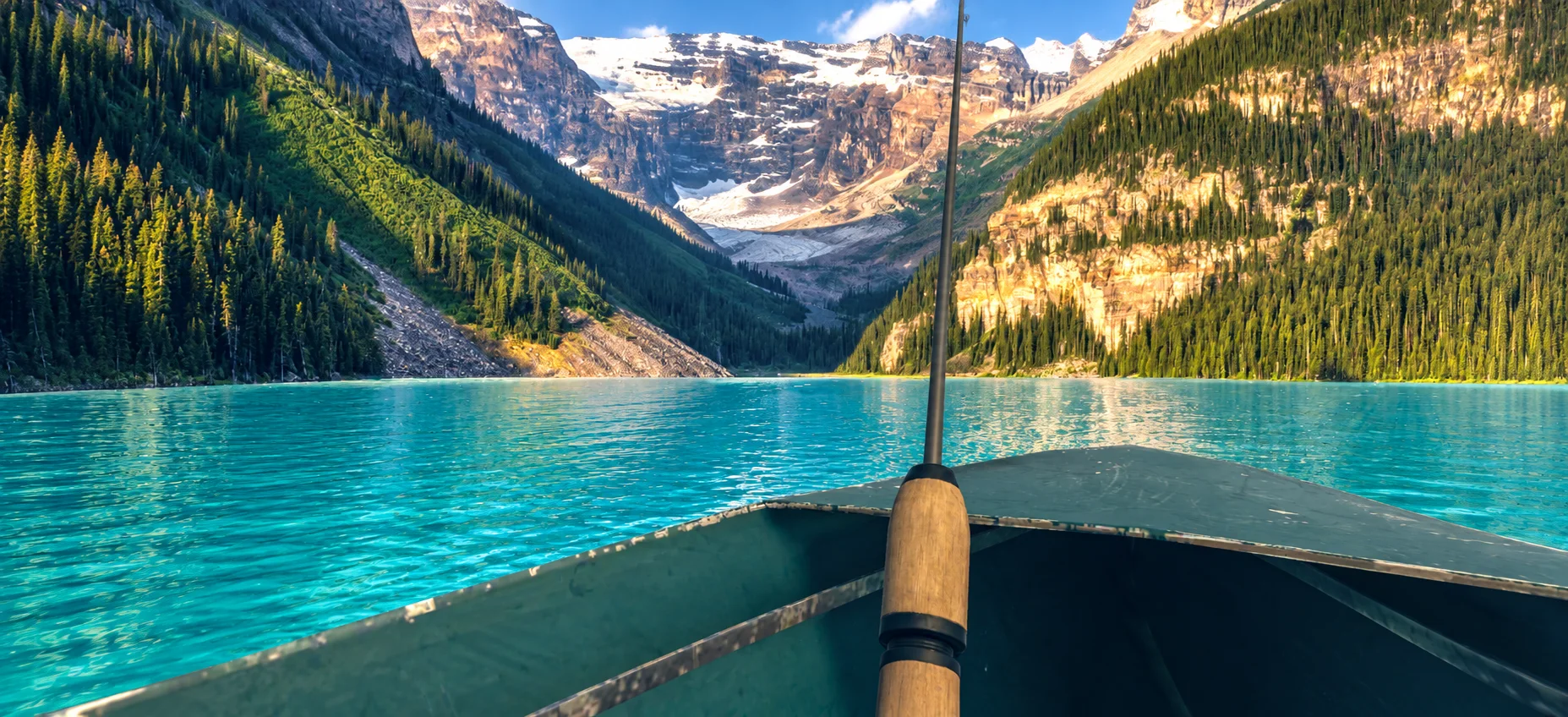 Fishing on the turquoise water of Lake Louise beneath the Canadian Rockies